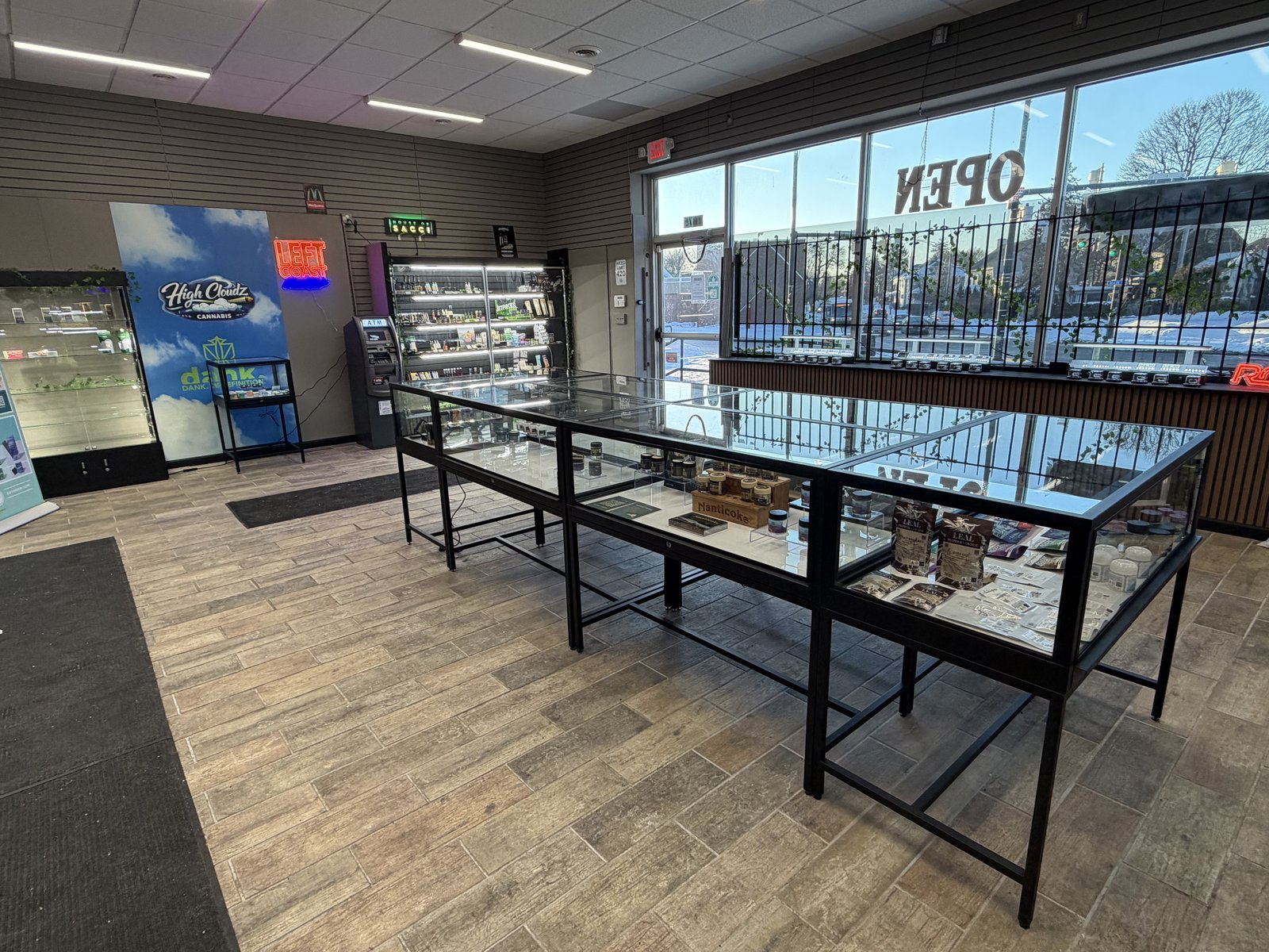 Flower jars and edibles in the display case at High Cloudz dispensary, Buffalo