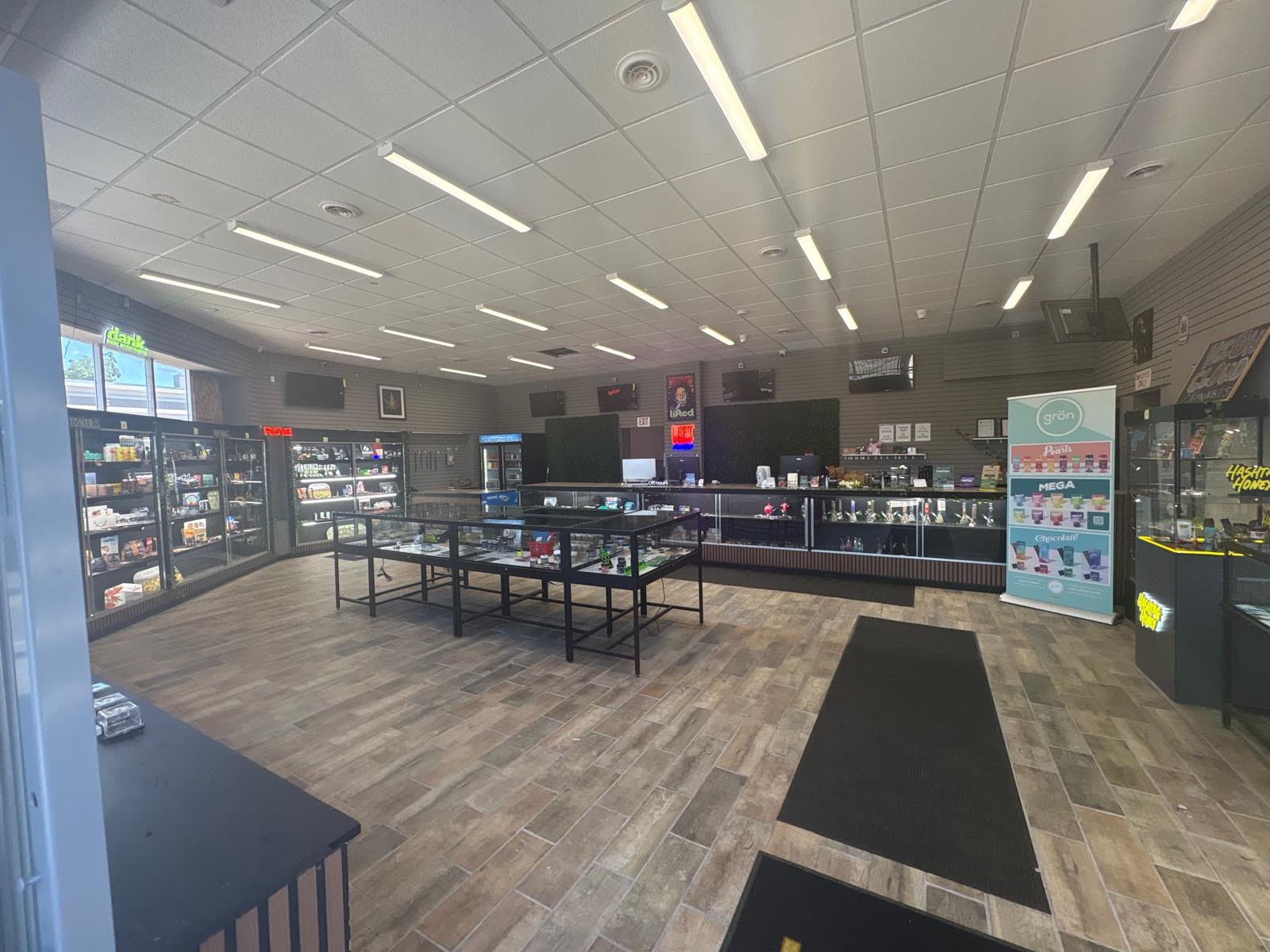 Inside High Cloudz Cannabis on Main St, Buffalo — bright dispensary floor with glass display cases